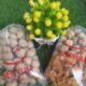 Kemasan bakso dan produk olahan daging merek Senyum dalam plastik bening dengan latar rumput sintetis